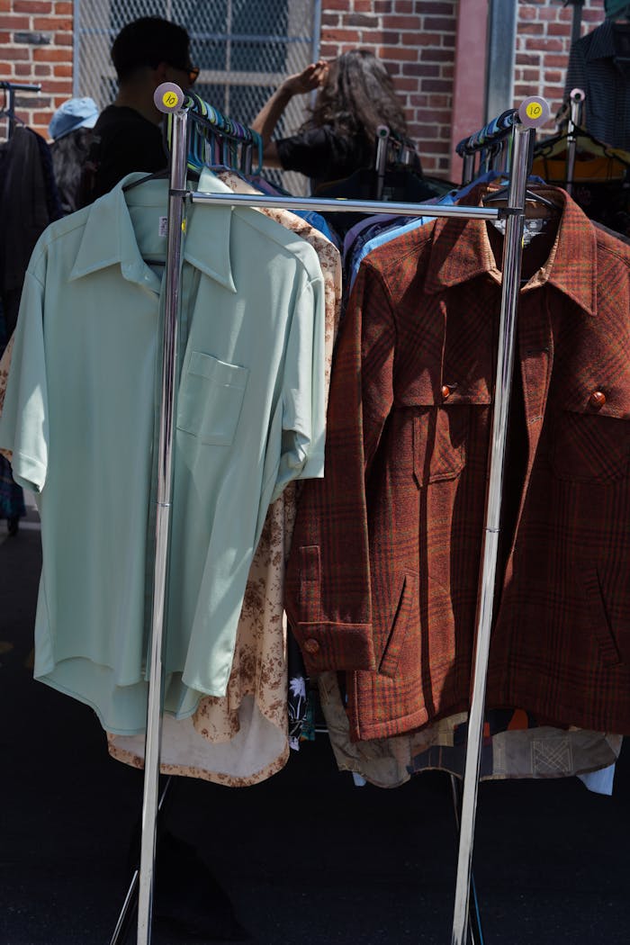 Vintage shirts hanging on a clothing rack at an outdoor market in Los Angeles, California.